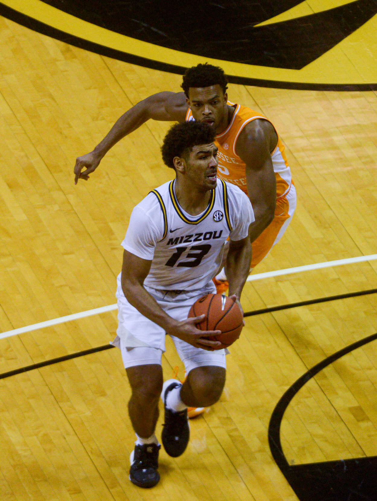 Missouri guard Mark Smith looks for teammates as Tennessee guard Josiah-Jordan James tries to stop him